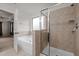 This bathroom has a soaking tub, a tile shower with glass doors, and a view into the bedroom at 4 Seawell Ct, Durham, NC 27703