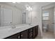 Bright bathroom featuring double sinks with marble counters and dark wood cabinets at 4 Seawell Ct, Durham, NC 27703