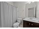Bathroom features a shower with striped curtain, toilet, and vanity with dark wood cabinets at 4 Seawell Ct, Durham, NC 27703