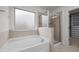 This bathroom has a soaking tub, a tile shower with glass doors, and a walk in closet at 4 Seawell Ct, Durham, NC 27703