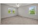 This bedroom features neutral carpeting and large windows for plenty of natural light at 4 Seawell Ct, Durham, NC 27703