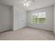 This bedroom features neutral carpeting and large windows for plenty of natural light at 4 Seawell Ct, Durham, NC 27703
