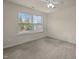 This bedroom features a window for natural light and neutral carpeting at 4 Seawell Ct, Durham, NC 27703