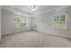 This bedroom features three windows for ample natural light and neutral carpeting at 4 Seawell Ct, Durham, NC 27703