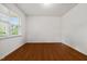 Empty bedroom with hardwood floors, a large window, and ample natural light at 4 Seawell Ct, Durham, NC 27703