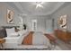 This bedroom features tray ceilings, two closets, an en suite bathroom, and a bench at the end of the bed at 4 Seawell Ct, Durham, NC 27703