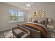 This bedroom features a window for natural light, stylish decor, and a bench at the end of the bed at 4 Seawell Ct, Durham, NC 27703