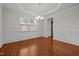 Formal dining room with hardwood floors, decorative molding, and a large window at 4 Seawell Ct, Durham, NC 27703