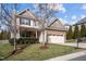 Charming two-story home featuring stone accents, a two-car garage, and a well-maintained front yard at 4 Seawell Ct, Durham, NC 27703