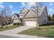 Charming homes featuring stone accents, two-car garages, and well-maintained front yards along a quiet street at 4 Seawell Ct, Durham, NC 27703