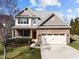 Two-story home boasts a brick facade, two car garage, manicured lawn, and charming curb appeal at 4 Seawell Ct, Durham, NC 27703
