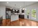 Spacious kitchen featuring stainless steel appliances, dark cabinets, granite counters, and an adjacent dining area at 4 Seawell Ct, Durham, NC 27703
