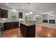 Bright kitchen boasts stainless appliances, dark wood cabinets, granite counters, and an open view of living area at 4 Seawell Ct, Durham, NC 27703