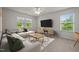 The bright living room is decorated with a comfortable sectional sofa and a modern entertainment center at 4 Seawell Ct, Durham, NC 27703
