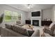 Bright living room with a fireplace, large window, neutral decor, and a comfortable seating arrangement at 4 Seawell Ct, Durham, NC 27703