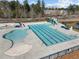 Aerial view of community swimming pool with slide and separate areas for lap swimming and recreation at 4 Seawell Ct, Durham, NC 27703