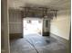 Spacious garage interior view with open door, overhead storage racks, and unfinished drywall at 4002 Silver Oak Ln # 96, Durham, NC 27703