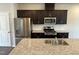 Kitchen featuring stainless steel appliances, granite counters, and dark cabinets at 4002 Silver Oak Ln # 96, Durham, NC 27703