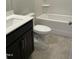 Bathroom with white countertop and shower, dark wood vanity, modern sink, and tile flooring at 4002 Silver Oak Ln, Durham, NC 27703