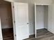 Bedroom with walk-in closet that features shelving and hanging rods, wood look flooring at 4002 Silver Oak Ln, Durham, NC 27703