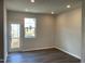 Bright living room featuring wood-look floors, fresh paint, recessed lighting, and a door to the outdoor deck at 4002 Silver Oak Ln, Durham, NC 27703