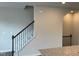 View of the home's staircase with sleek, dark wood railing and white risers, and neutral walls at 4002 Silver Oak Ln, Durham, NC 27703