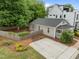 Aerial view of the home with a well-kept lawn, driveway, and a charming exterior, nestled amongst mature trees at 401 Haywood St, Raleigh, NC 27601