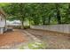 Large backyard featuring mature trees, wood fencing and a stone path at 401 Haywood St, Raleigh, NC 27601