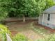 The backyard features a stone path and patio, complemented by mature trees and a fenced boundary for added privacy at 401 Haywood St, Raleigh, NC 27601