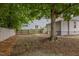 View of the yard, showing a large tree, fence, and the side of the home, creating a private outdoor area at 401 Haywood St, Raleigh, NC 27601