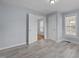 Bright, light-blue bedroom with wood-look floors, interior doors and windows providing natural light at 401 Haywood St, Raleigh, NC 27601