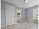 Cozy bedroom with light-blue walls, two windows and wood-look floors at 401 Haywood St, Raleigh, NC 27601