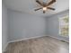 Simple bedroom features wood-look flooring, a window with natural light, and neutral walls at 401 Haywood St, Raleigh, NC 27601