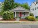 Charming bungalow with a cozy front porch, bright red door, and well-maintained landscaping at 401 Haywood St, Raleigh, NC 27601