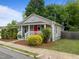 Quaint home with a front porch, featuring a vibrant red door and mature landscaping at 401 Haywood St, Raleigh, NC 27601