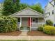 Charming bungalow with a cozy front porch, bright red door, and well-maintained landscaping at 401 Haywood St, Raleigh, NC 27601