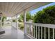 Inviting covered front porch with white railing and lush landscaping for privacy at 401 Haywood St, Raleigh, NC 27601