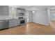 Bright kitchen featuring stainless steel appliances, gray cabinetry, and hardwood floors at 401 Haywood St, Raleigh, NC 27601