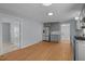 Open kitchen boasts stainless steel appliances, granite countertops, and wood-look flooring at 401 Haywood St, Raleigh, NC 27601