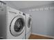 Laundry room with front-loading washer and dryer and wall hooks at 401 Haywood St, Raleigh, NC 27601