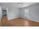 Open-concept living room painted light-blue with hardwood-style floors, access to kitchen and natural light at 401 Haywood St, Raleigh, NC 27601