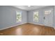 A bright living room featuring wood floors and an abundance of natural light from the two windows at 401 Haywood St, Raleigh, NC 27601