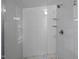Bathroom featuring a luxurious tiled shower with glass door and shower head at 401 Haywood St, Raleigh, NC 27601