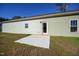 The home's backyard features a concrete patio area, grass, and the home's exterior at 404 S Eastwood Dr, Benson, NC 27504