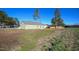 Rear exterior view of a home with a green yard and newly planted grass at 404 S Eastwood Dr, Benson, NC 27504