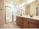 Bathroom features a double vanity, an enclosed shower, and modern fixtures at 404 S Eastwood Dr, Benson, NC 27504