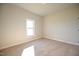 Sunlit bedroom with a neutral color palette and carpet flooring at 404 S Eastwood Dr, Benson, NC 27504