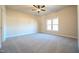Spacious bedroom with neutral carpet, ceiling fan, and bright window at 404 S Eastwood Dr, Benson, NC 27504
