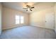 Neutral bedroom boasts large window and carpet flooring at 404 S Eastwood Dr, Benson, NC 27504