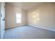 A simple bedroom with neutral walls, carpet flooring, and a window for natural light at 404 S Eastwood Dr, Benson, NC 27504